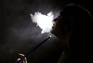 The girl smokes a hookah