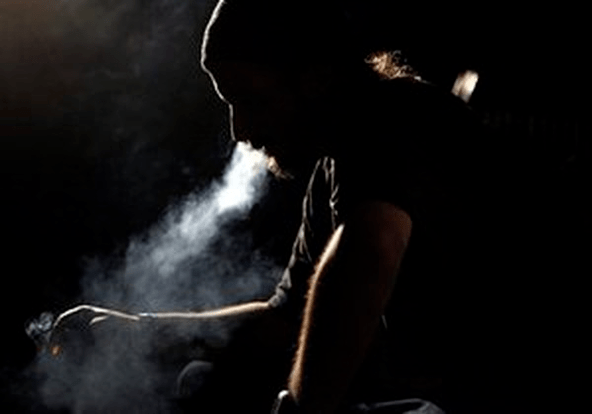 a man smokes a cigarette